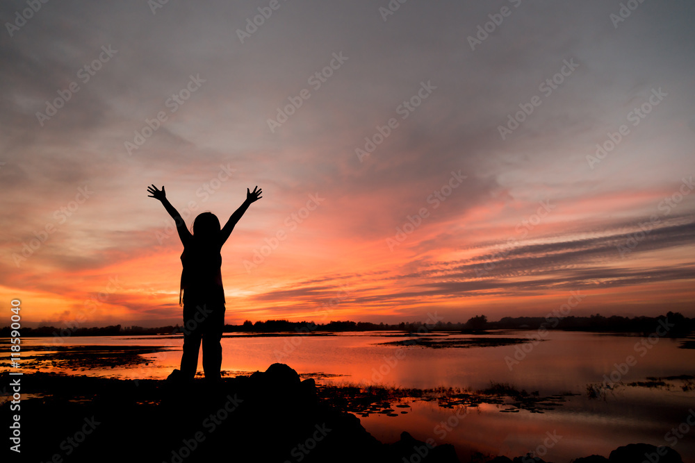 silhouette girl Happy celebrating winning success at sunset