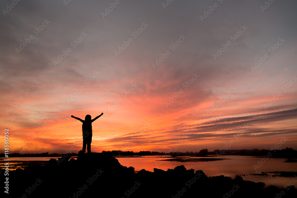 silhouette girl Happy celebrating winning success at sunset