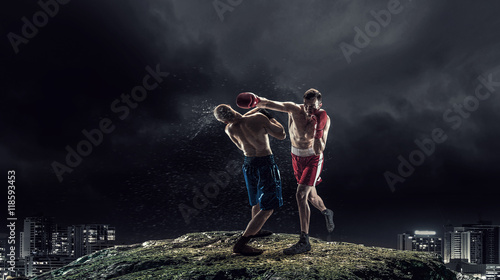 Fototapeta Naklejka Na Ścianę i Meble -  Box fighters trainning outdoor . Mixed media