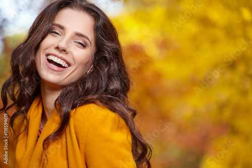 Beautiful young woman in autumn styling on the background of aut