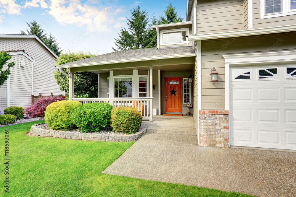 Obraz premium American house exterior with double garage and well kept lawn.