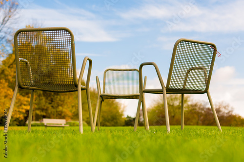 Chair on green grass in park