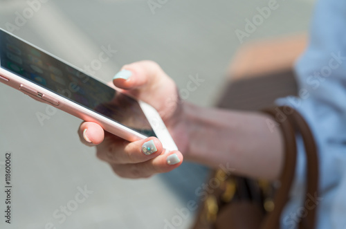 Girl's hand with smartphone