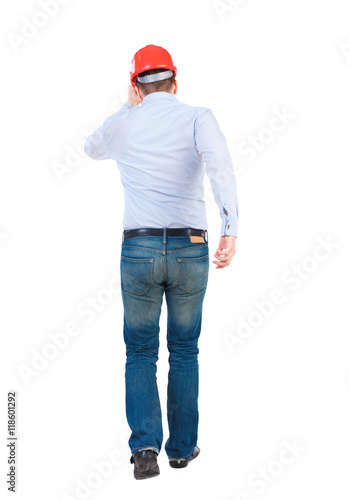 Back view of running engineer in helmet. Walking guy in motion. Rear view people collection. Backside view of person. Isolated over white background. Bearded businessman in a white shirt and a helmet