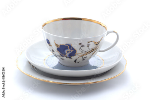 Porcelain cup, plate and saucer on a white background