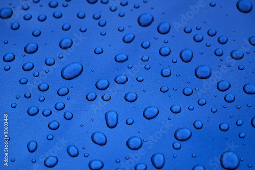 water drops on blue car body threated with protective coating