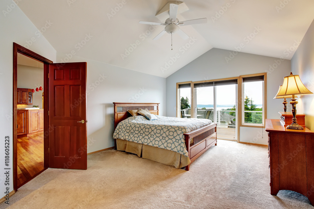 Fototapeta premium Bedroom interior with carpet floor and exit to balcony.