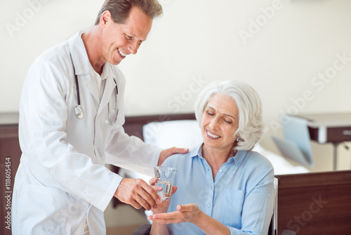 Senior patient taking pills