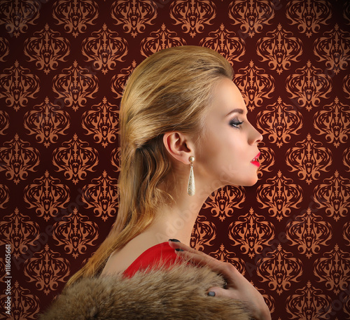 Elegant woman in fur cape o...