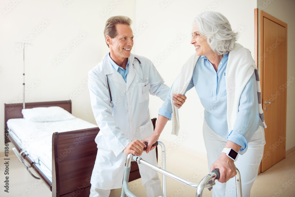 Fototapeta premium Doctor helping patient at hospital ward