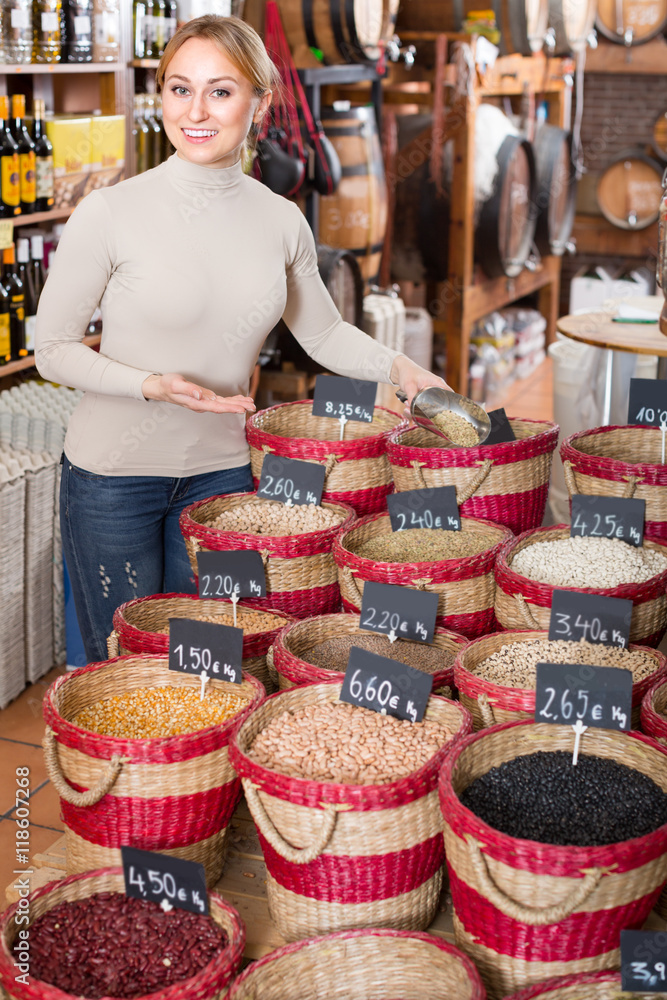 woman taking dried beans