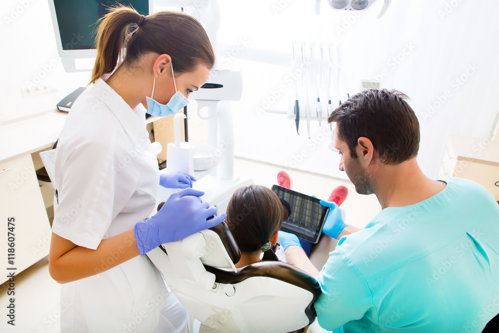 Dentist with a little girl and a Tablet PC. Dentist with a little girl and a Tablet PC.