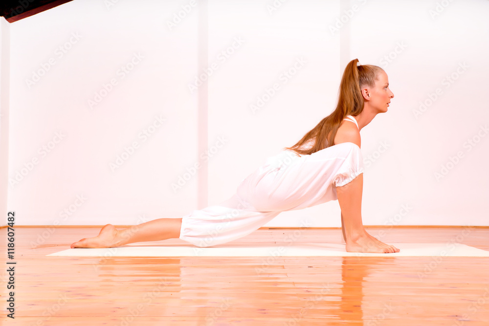Woman practicing Yoga in a Studio.. Woman practicing Yoga in a Studio..