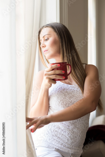 Beautiful woman looking out of the window