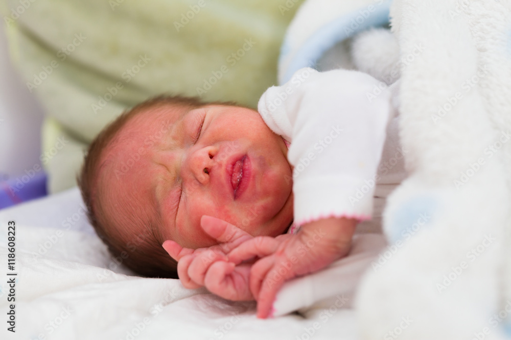Little newborn child sleeping in her mother's arms some hours after her birth. Little newborn child sleeping in her mother's arms some hours after her birth.