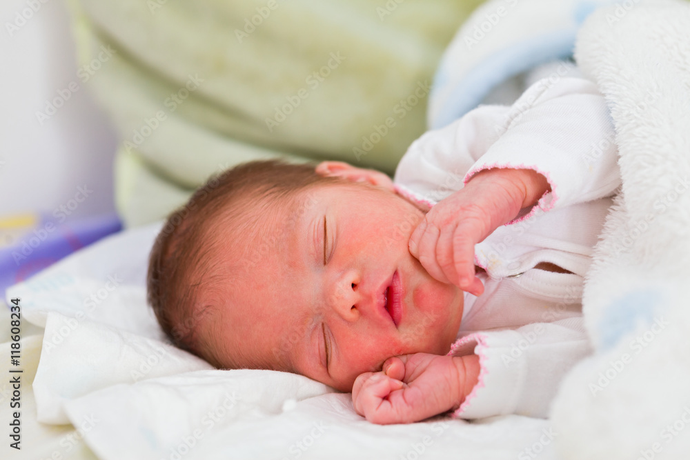 Little newborn child sleeping in her mother's arms some hours after her birth. Little newborn child sleeping in her mother's arms some hours after her birth.