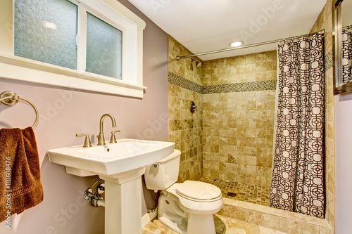 Bathroom with purple walls  green shower and nice curtains.