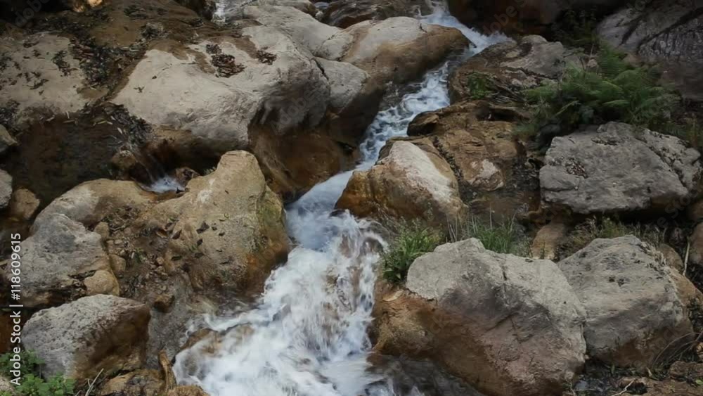 White mountain stream water, flowing through the stones. Neergarh Waterfall - famous tourist place near by Rishikesh, India White mountain stream water, flowing through the stones. Neergarh Waterfall - famous tourist place near by Rishikesh, India