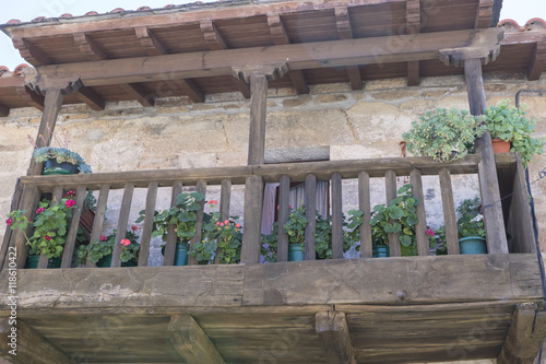 balcony with flowers, traditional stone houses in the province o © Fernando Cortés