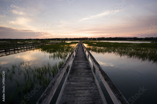 Fototapeta Naklejka Na Ścianę i Meble -  boardwalk in the marsh at sunset, Pawleys Island, South Carolina