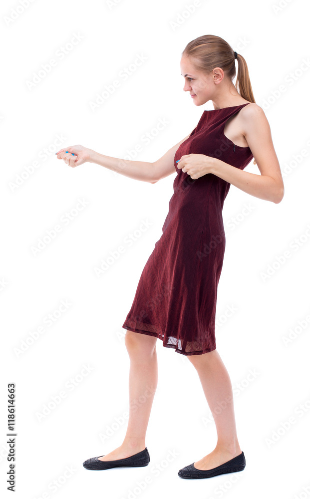 back view of standing girl pulling a rope from the top or cling to something. girl watching. Rear view people collection. backside view of person. Isolated over white background. A girl in a back view of standing girl pulling a rope from the top or cling to something. girl watching. Rear view people collection. backside view of person. Isolated over white background. A girl in a