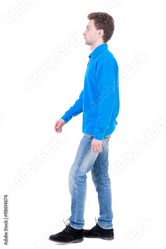 Back view of going handsome man. walking young guy . Rear view people collection. backside view of person. Isolated over white background. Curly boy in the blue jacket is thoughtfully to one side.
