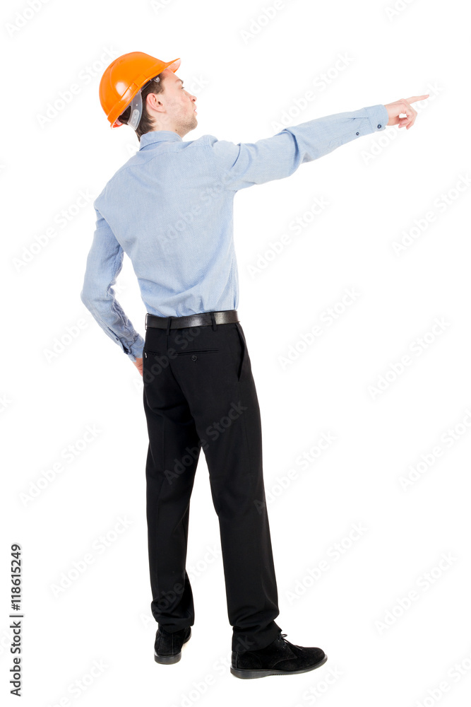 Back view of pointing young men in helmet. Young guy gesture. Rear view people collection. backside view of person. Isolated over white background. Curly businessman in a light jacket and a helmet Back view of pointing young men in helmet. Young guy gesture. Rear view people collection. backside view of person. Isolated over white background. Curly businessman in a light jacket and a helmet