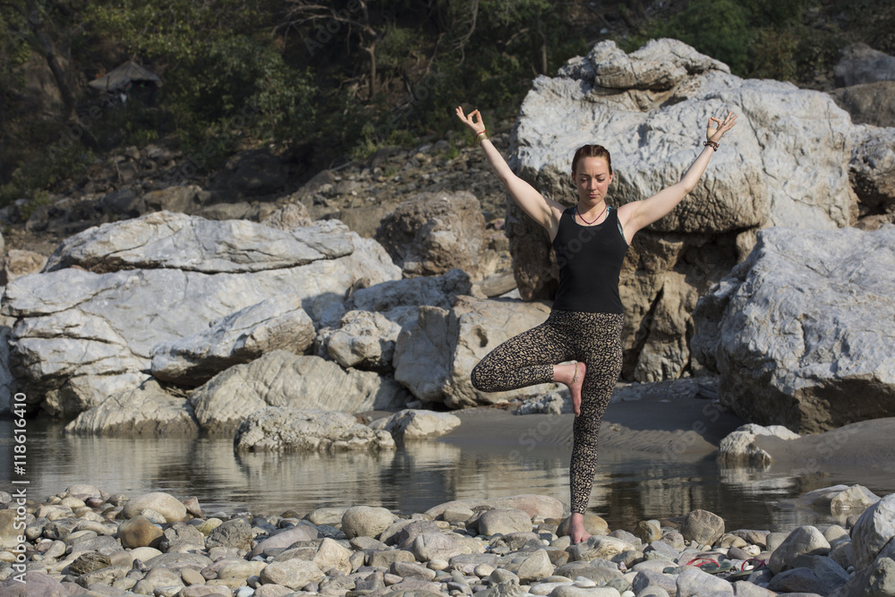 Amazing beautiful girl does yoga near the river. Amazing beautiful girl does yoga near the river.