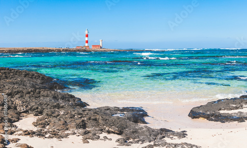 Seaside view in Fuerteventura with clear water and lighthouse photo