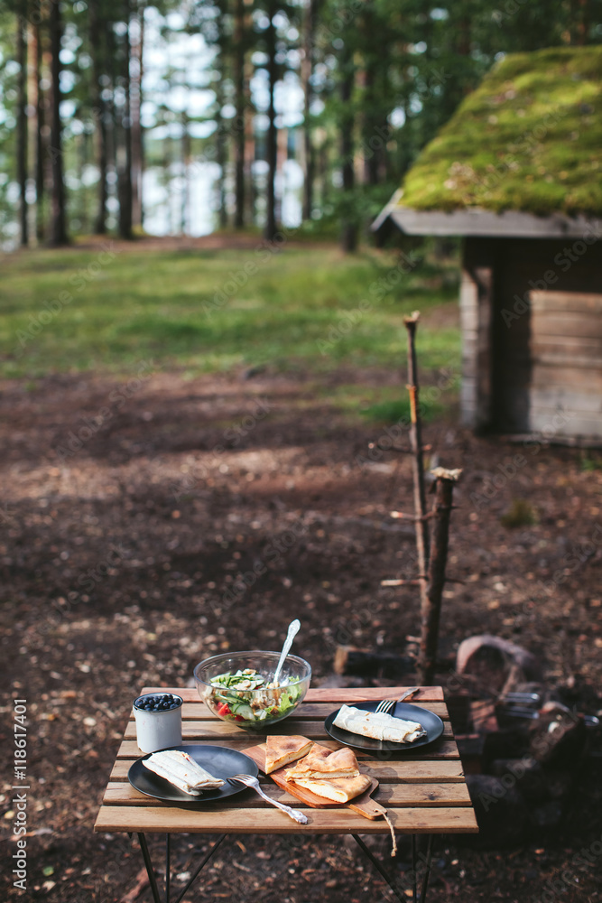 picnic in the woods. kebab, salad and berries picnic in the woods. kebab, salad and berries