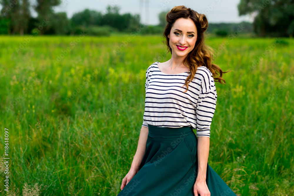 Beautiful young girl in retro style walks in the meadow Beautiful young girl in retro style walks in the meadow
