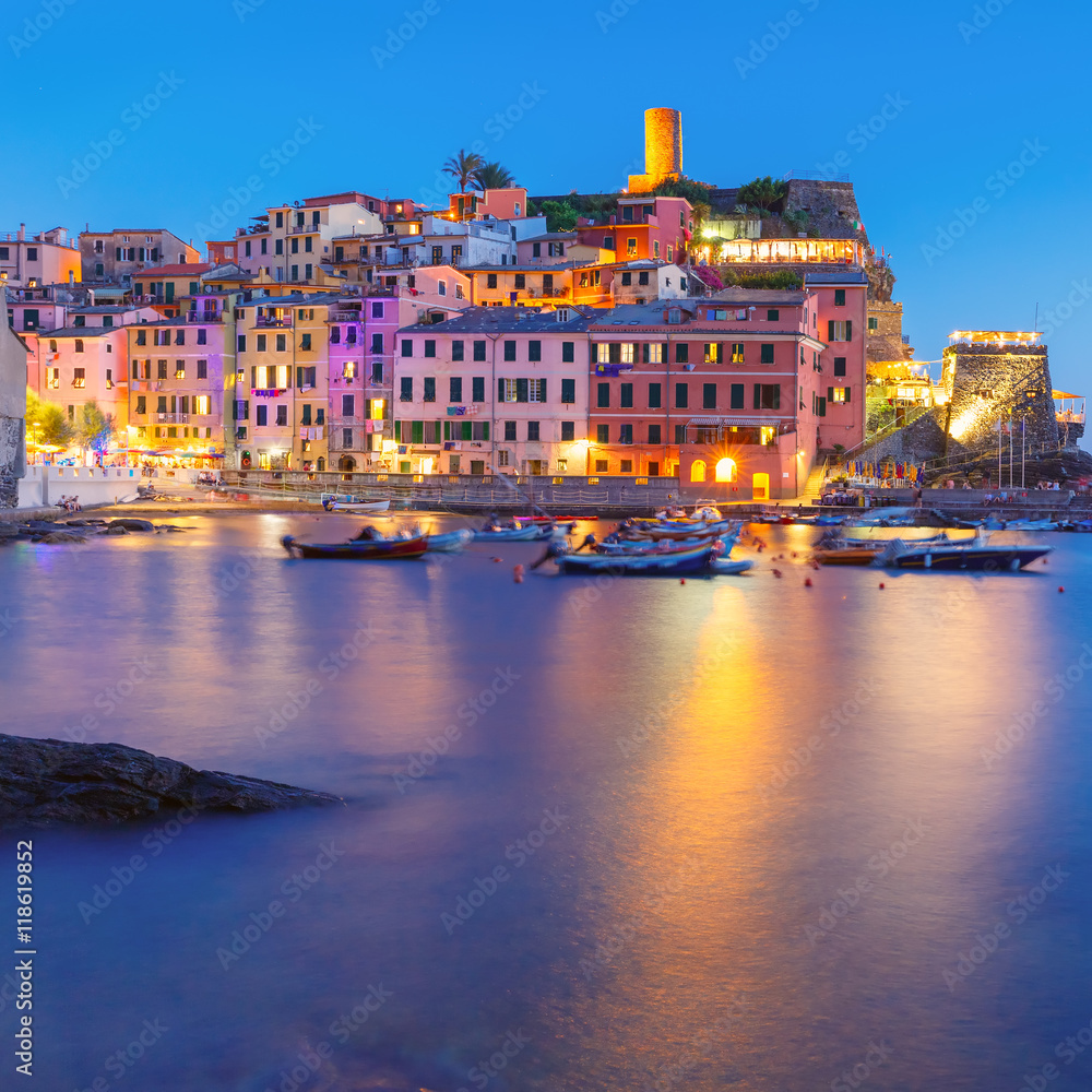 Night fishing village Vernazza with lookout tower of Doria Castle to protect the village from pirates, Five lands, Cinque Terre National Park, Liguria, Italy.