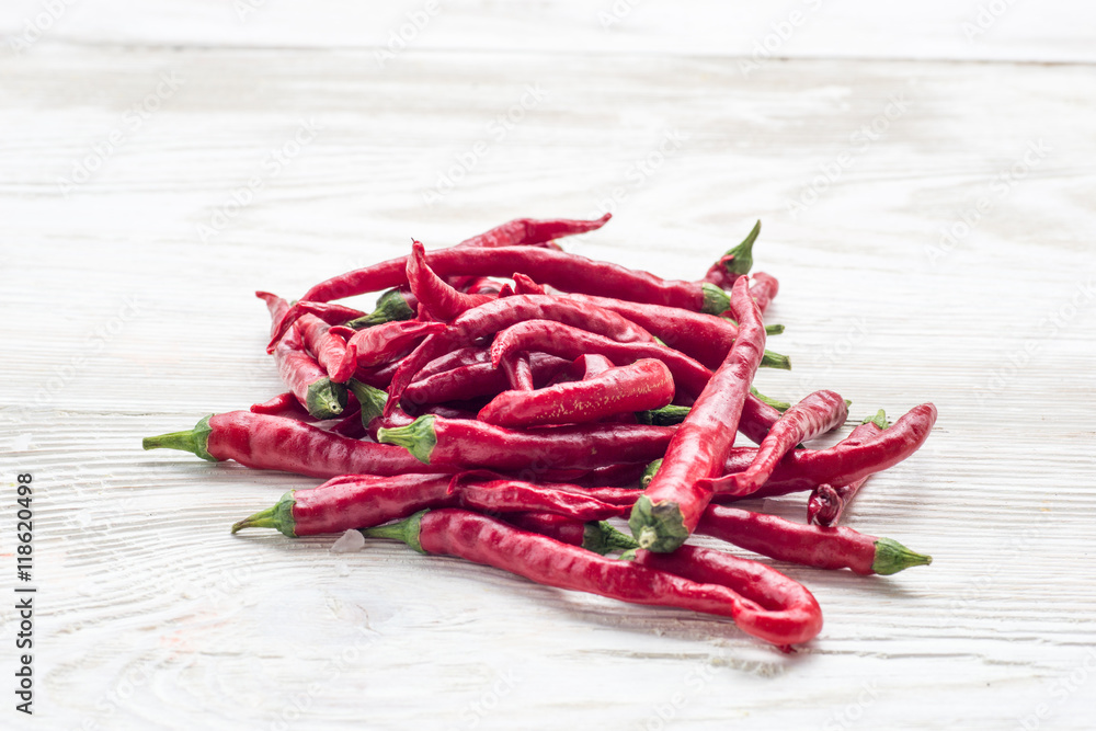 Red paprika with chilli peppers on wooden background Red paprika with chilli peppers on wooden background
