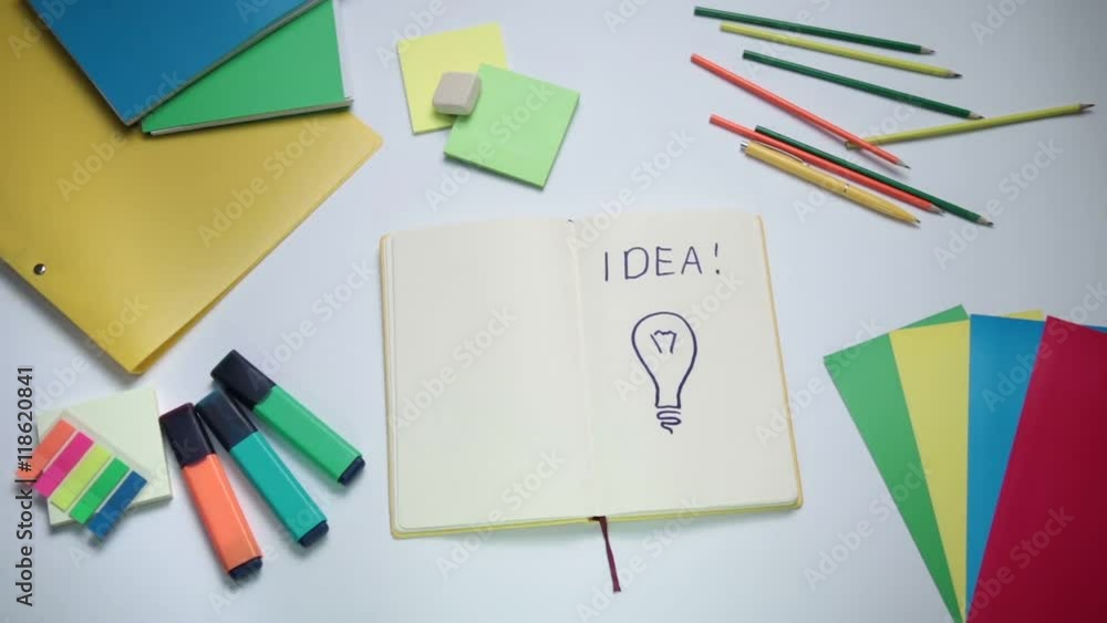 Word Idea and light bulb written on white note pad Word Idea and light bulb written on white note pad