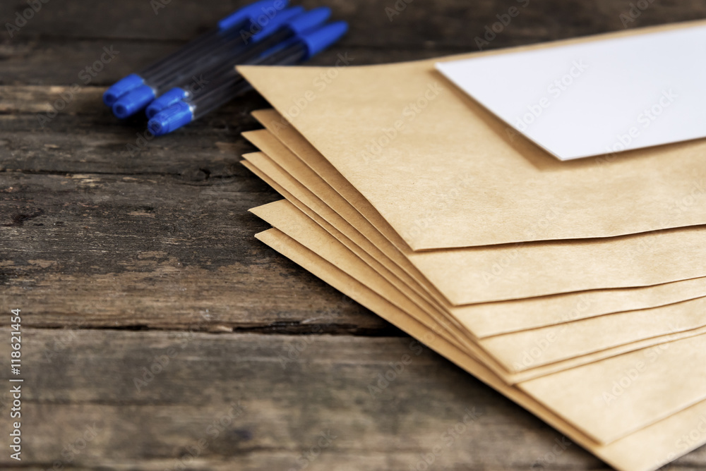 Envelopes with white 
paper and blue pens