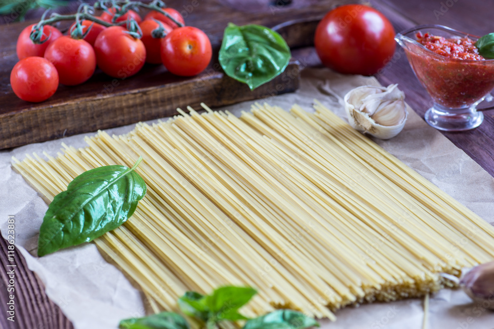 Pasta ingredients. tomato, garlic, pepper, and oil on wooden bac Pasta ingredients. tomato, garlic, pepper, and oil on wooden bac