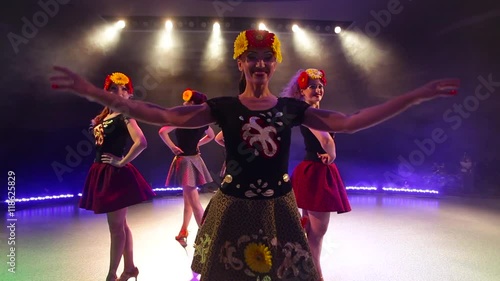 young women in traditional Russian dress dancing on stage photo