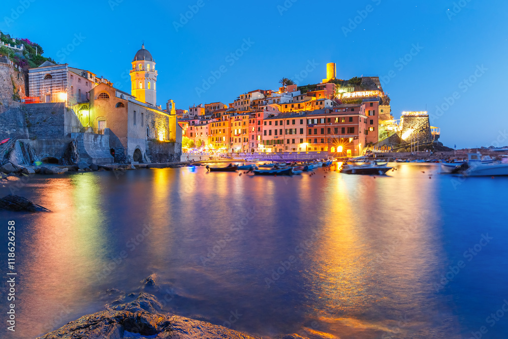 Night fishing village Vernazza with Santa Margherita di Antiochia Church and lookout tower of Doria Castle, Five lands, Cinque Terre National Park, Liguria, Italy.