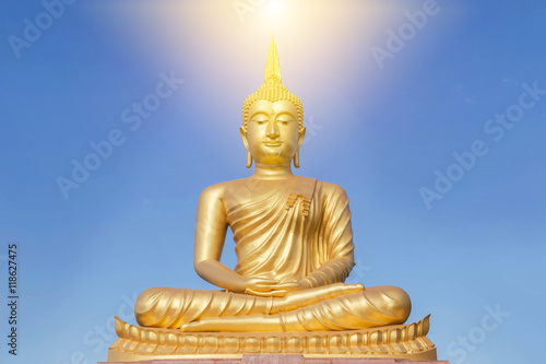 big golden buddha statue sitting in thai temple 