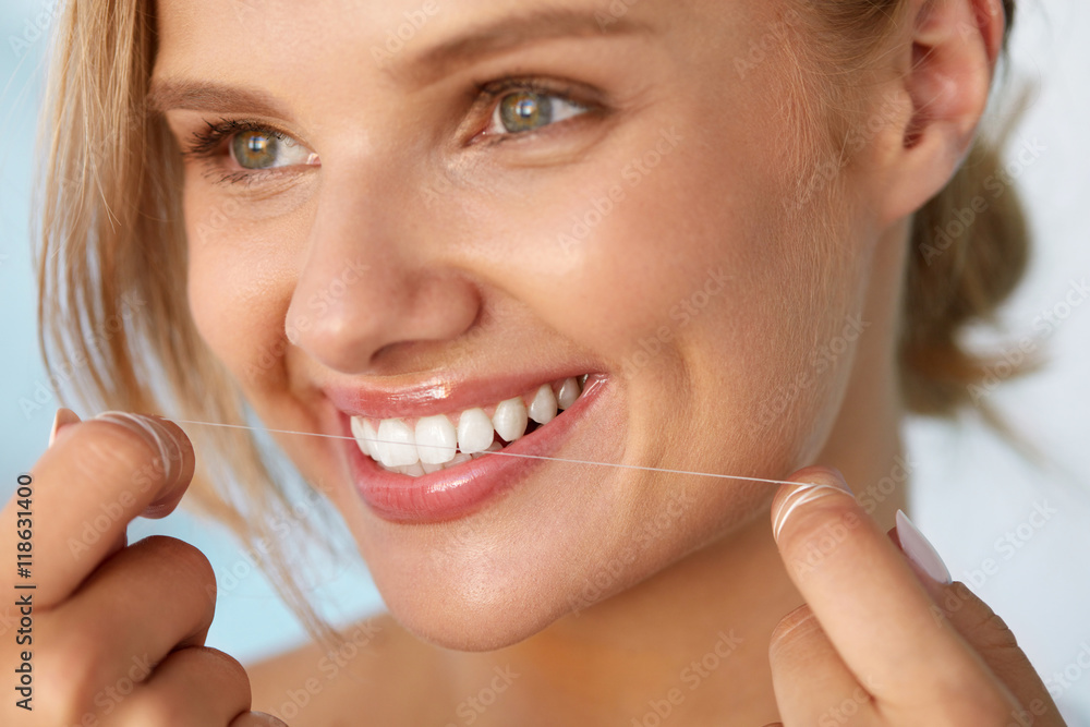 Dental Health. Woman With Beautiful Smile Flossing Healthy Teeth. High Resolution Image Dental Health. Woman With Beautiful Smile Flossing Healthy Teeth. High Resolution Image