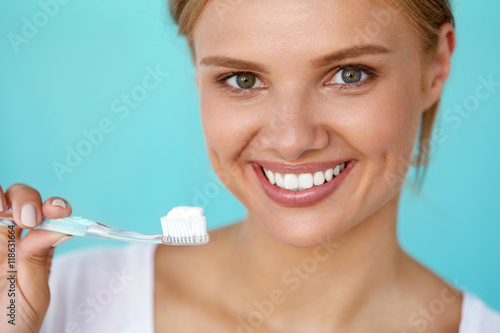 Woman With Beautiful Smile  Healthy White Teeth With Toothbrush. High Resolution Image