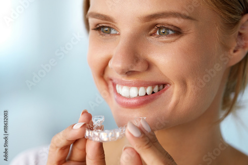 Fototapeta Naklejka Na Ścianę i Meble -  Smiling Woman With White Teeth Holding Teeth Whitening Tray. High Resolution Image