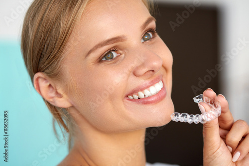 Smiling Woman With White Teeth Holding Teeth Whitening Tray. High Resolution Image