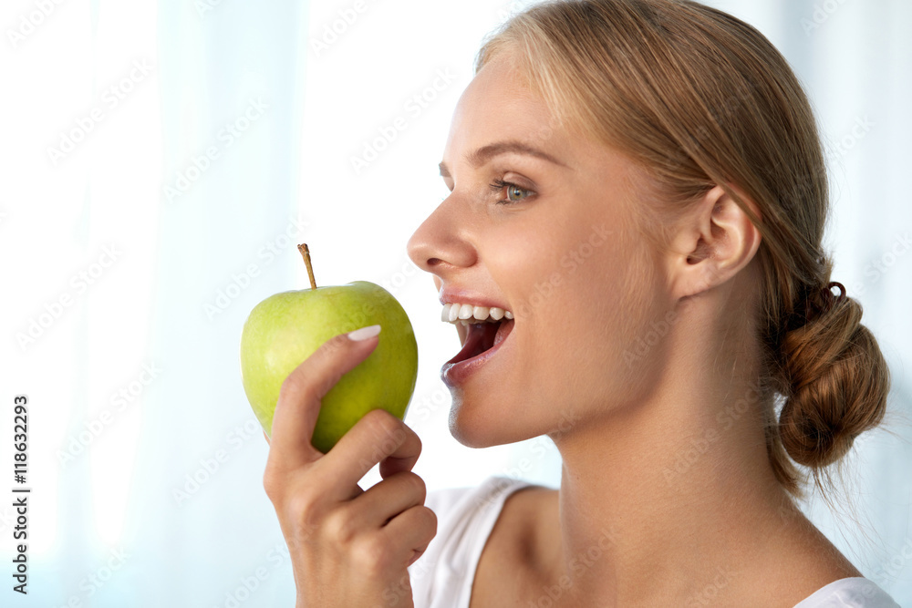 Beautiful Smiling Woman With White Teeth Eating Green Apple. High Resolution Image Beautiful Smiling Woman With White Teeth Eating Green Apple. High Resolution Image