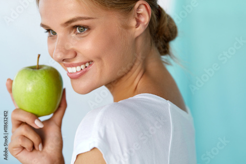 Happy Woman With Beautiful Smile, Healthy Teeth Holding Apple. High Resolution Image