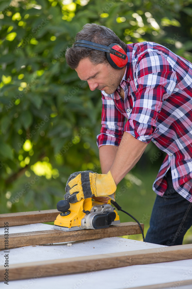 Carpenter cutting plank by circular saw Carpenter cutting plank by circular saw