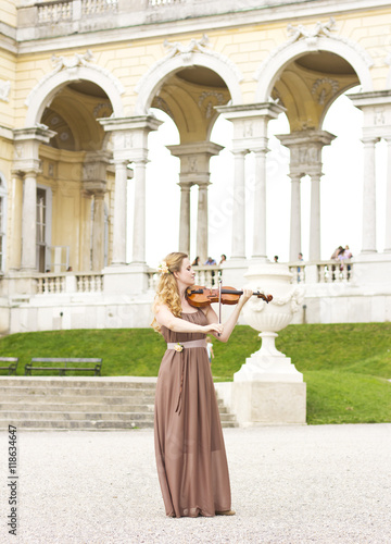 Photography Beautiful smiling girl playing on the violin outdoors
