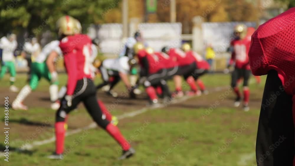 Anxious football player watching game, defocused rival teams fighting for ball