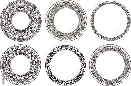 Set of five ornamental black floral round frames on a white background