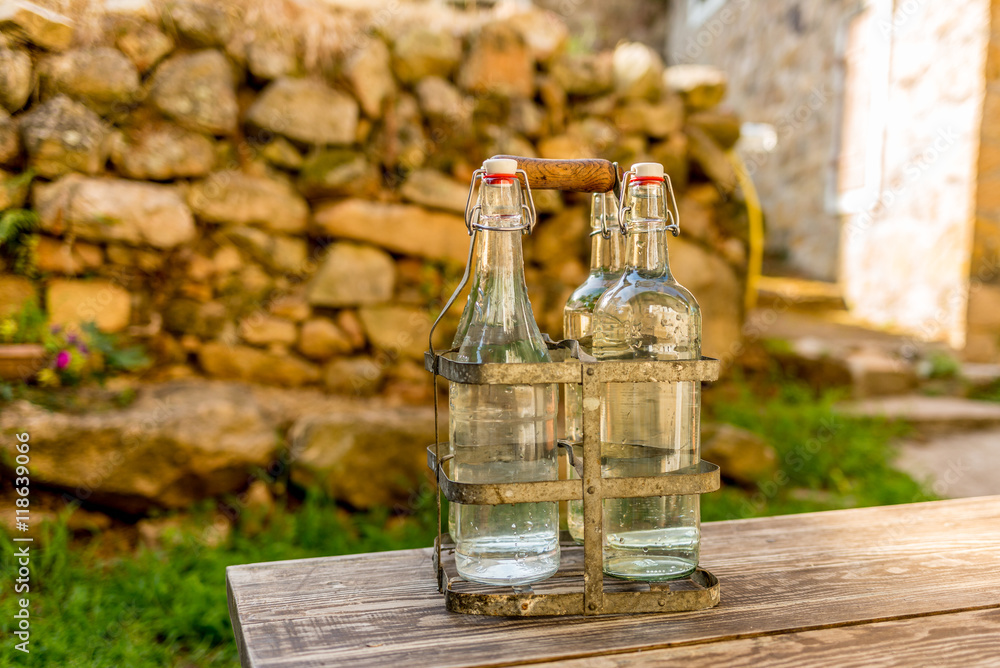 Bottles of cold spring water during summer in the mountains in C Bottles of cold spring water during summer in the mountains in C